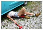 woman mechanic under a car