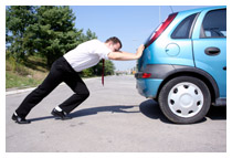 Man pushing his car