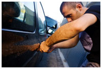 A car thief stealing a car