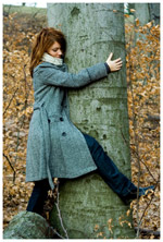 A woman hugging a tree