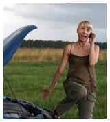 A woman on the phone with a broken down car