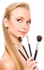 A woman holding makeup brushes