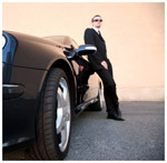 Man standing next to an expensive car