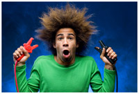 A man holding jumper cables with wild hair