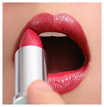 A close up of a woman applying lipstick