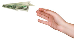 A hand throwing a paper airplane made from a dollar